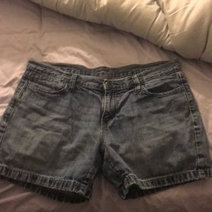 They are A dark blue washed denim shorts
